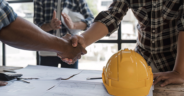 general contractor handshake over project plans